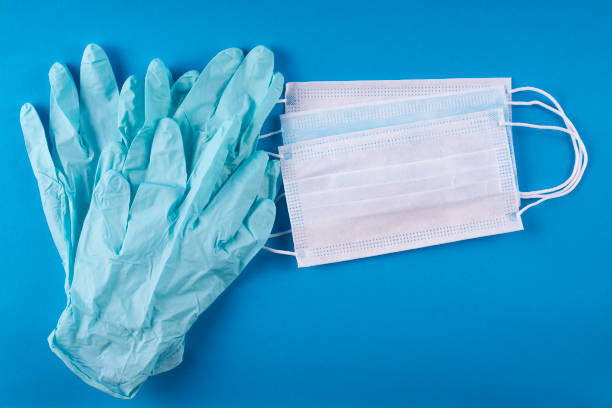 Medical bandages and gloves on a blue background. Medical bandages and gloves on a blue background.